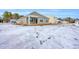 Tan house exterior with covered patio and snowy yard at 281 Columbus St., Conway, SC 29526