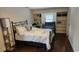 Inviting bedroom with queen bed, built in bookshelves and hardwood floors at 305 W Raft St., Nichols, SC 29581