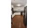 Well-lit kitchen featuring white cabinets, stainless steel appliances, and hardwood floors at 305 W Raft St., Nichols, SC 29581