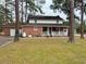 Back view of a two-story brick home with a large lawn, attached garage and a rear porch at 305 W Raft St., Nichols, SC 29581