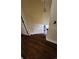 View of staircase with dark wood stairs and white railing, illuminated by a hanging light at 305 W Raft St., Nichols, SC 29581