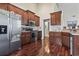 Well-equipped kitchen features stainless steel appliances, wood cabinetry, and attractive hardwood floors at 3141 Shorecrest Bay Dr., Murrells Inlet, SC 29576