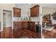 Efficient kitchen featuring dark wood cabinets, tile backsplash, and modern appliances and open layout at 3141 Shorecrest Bay Dr., Murrells Inlet, SC 29576