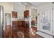 Open kitchen featuring wood floors, cabinets, and seamless access to the dining area and decorative glass front door at 3141 Shorecrest Bay Dr., Murrells Inlet, SC 29576