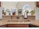 Close-up of a kitchen sink with counter decor and a arched window providing natural light at 3141 Shorecrest Bay Dr., Murrells Inlet, SC 29576