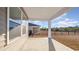 Covered back patio with view of black aluminum fence and treeline at 3409 Ashridge Way, Conway, SC 29526