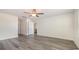 Bedroom with gray wood-look floors, open door and ceiling fan at 3409 Ashridge Way, Conway, SC 29526