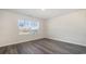 Well-lit bedroom with wood-look floors and large window at 3409 Ashridge Way, Conway, SC 29526