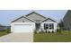 Charming one-story house with gray siding, white garage door, and landscaped lawn at 3410 Ashridge Way, Conway, SC 29526