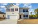 Two-story house with a white exterior, maroon shutters, and a two-car garage at 3415 Ashridge Way, Conway, SC 29526