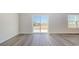 Living room with grey vinyl plank flooring and sliding glass doors at 3415 Ashridge Way, Conway, SC 29526