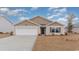 Tan exterior house with a white garage door and landscaping at 3422 Ashridge Way, Conway, SC 29526