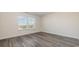 Bedroom with grey vinyl plank flooring and window at 3433 Ashridge Way, Conway, SC 29526