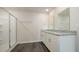 Bathroom featuring dual sinks, granite counters, a framed mirror, and a glass-enclosed shower at 3438 Ashridge Way, Conway, SC 29526