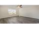 Well-lit bedroom with a ceiling fan and a large window offering natural light and gray wood floors at 3438 Ashridge Way, Conway, SC 29526