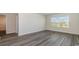 Simple bedroom with gray vinyl flooring and a large window at 3488 Ashridge Way, Conway, SC 29526