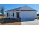 White house with a gray roof, blue door, and landscaped yard at 3489 Ashridge Way, Conway, SC 29526