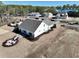 Aerial view of a white single-Gathering home with a dark roof, landscaped backyard, and fire pit at 35 Northbrook Dr, Murrells Inlet, SC 29576