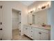 Bright bathroom featuring a double vanity, modern lighting fixtures and a walk-in closet at 35 Northbrook Dr, Murrells Inlet, SC 29576