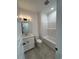 A well-lit bathroom featuring modern vanity, toilet, and tub and shower combo at 35 Northbrook Dr, Murrells Inlet, SC 29576