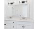 Bright bathroom featuring a double vanity, modern lighting fixtures and a large mirror at 35 Northbrook Dr, Murrells Inlet, SC 29576