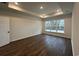 Bright bedroom with hardwood floors, a tray ceiling, recessed lighting, and a large window offering natural light at 35 Northbrook Dr, Murrells Inlet, SC 29576