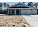 Charming one-story home featuring a two-car garage, neutral siding, and covered front porch at 35 Northbrook Dr, Murrells Inlet, SC 29576