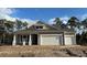 Two-story craftsman style home with beige exterior and two-car garage at 35 Northbrook Dr, Murrells Inlet, SC 29576