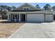 Charming one story home with a concrete driveway, two-car garage, and neutral colored siding at 35 Northbrook Dr, Murrells Inlet, SC 29576