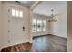 Bright foyer with wood floors, a white front door, and a view into the adjacent dining area at 35 Northbrook Dr, Murrells Inlet, SC 29576