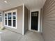 A close up of the front entrance showing the front door and the window at 35 Northbrook Dr, Murrells Inlet, SC 29576