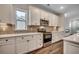 Updated kitchen with white cabinets, a stainless steel stove, and a decorative backsplash at 35 Northbrook Dr, Murrells Inlet, SC 29576