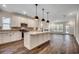 Spacious kitchen with white cabinets, quartz countertops, stainless appliances, and a large island at 35 Northbrook Dr, Murrells Inlet, SC 29576