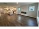 Open-concept living room with hardwood floors, a modern fireplace, and an adjacent kitchen area with an island at 35 Northbrook Dr, Murrells Inlet, SC 29576