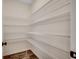 Walk-in pantry with white wire shelving and wood-look flooring provides ample storage at 35 Northbrook Dr, Murrells Inlet, SC 29576