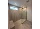Modern tiled shower with glass enclosure, bench and window at 35 Northbrook Dr, Murrells Inlet, SC 29576