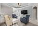 Relaxing living room featuring neutral carpeting, comfy seating, and a large TV at 409 Carrick Loop, Longs, SC 29568