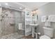Bright bathroom featuring an accessible shower with bench, ample storage, and pedestal sink at 4103 N Ocean Blvd. # 504, North Myrtle Beach, SC 29582