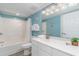 Clean bathroom featuring a bathtub, shower, vanity, and bright blue walls at 4103 N Ocean Blvd. # 504, North Myrtle Beach, SC 29582