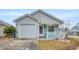 Charming single-story home features a decorative fence, front porch, and an attached garage at 412 Chesterfield Ct., Myrtle Beach, SC 29577