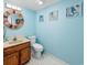 Clean bathroom with hexagon tile floor, wooden vanity, and coastal-themed art at 4246 Pinehurst Circle # O-6, Little River, SC 29566