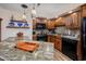 Well-equipped kitchen featuring granite countertops and wood cabinets at 4246 Pinehurst Circle # O-6, Little River, SC 29566