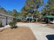 Long driveway with a carport and landscaping at 430 Long Lake Circle, Conway, SC 29527