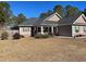 House exterior featuring a two-car garage and landscaped yard at 430 Long Lake Circle, Conway, SC 29527