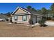 View of a two-car garage with light tan siding at 430 Long Lake Circle, Conway, SC 29527