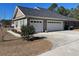 Two-car garage with white doors and a concrete driveway at 430 Long Lake Circle, Conway, SC 29527