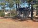 Small storage shed with white trim and a seating area at 430 Long Lake Circle, Conway, SC 29527