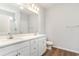 Double vanity bathroom with white cabinets and quartz countertops at 431 Lifestyle Court, Surfside Beach, SC 29575