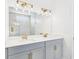 Bright bathroom featuring a double vanity with modern gold fixtures and a large mirror at 45 Northbrook Dr, Murrells Inlet, SC 29576