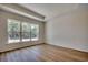 Bedroom with wood flooring, large windows overlooking the backyard, and a tray ceiling at 45 Northbrook Dr, Murrells Inlet, SC 29576